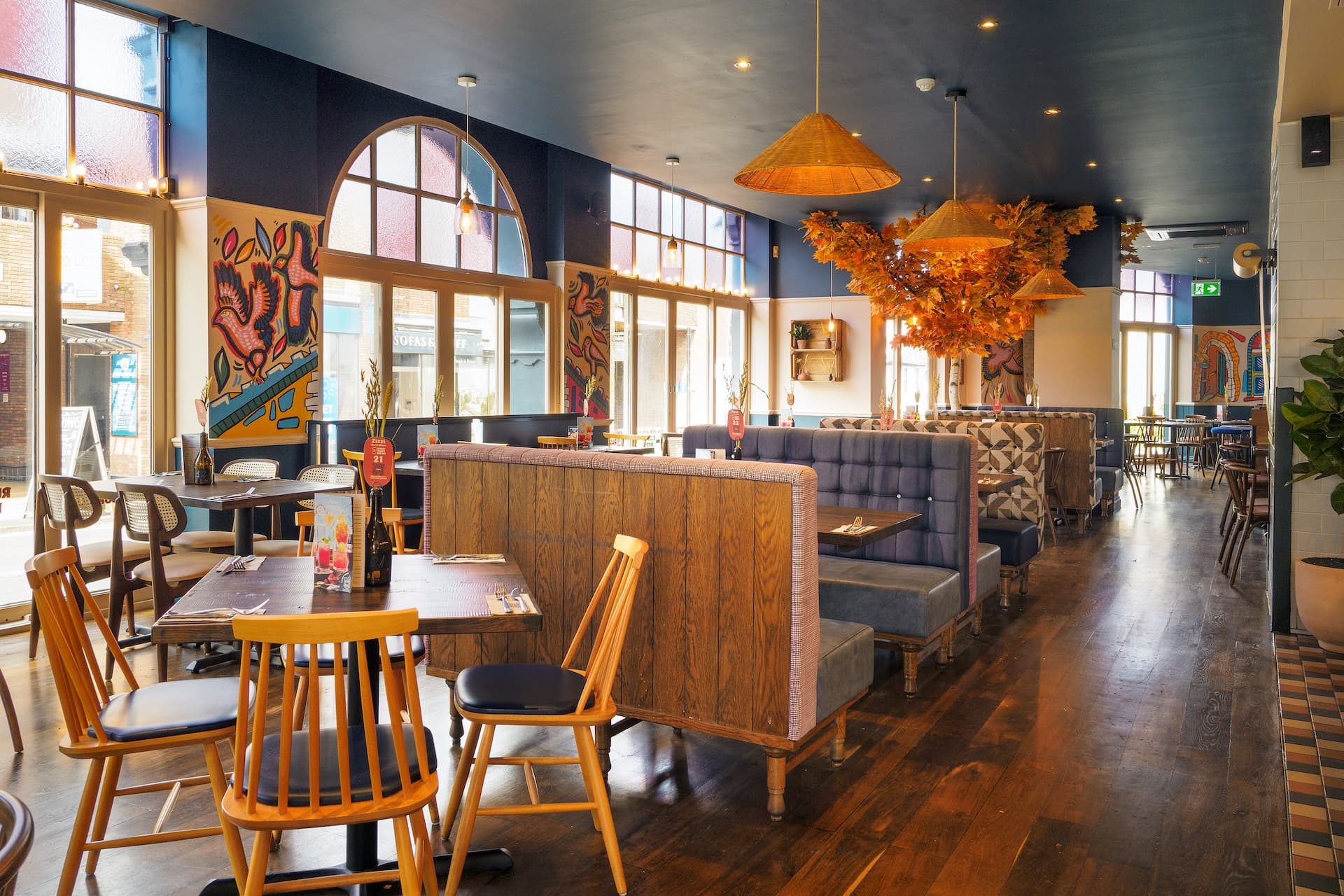 Stylish dining area at Zizzi St Albans with modern decor and natural accents.