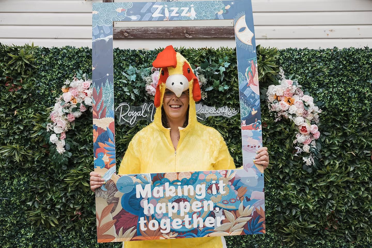 Staff member holding a 'making it happen together' sign