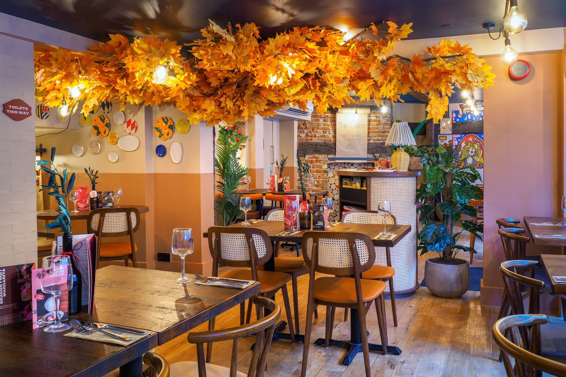 Zizzi Windsor interiors with golden tree and table seating