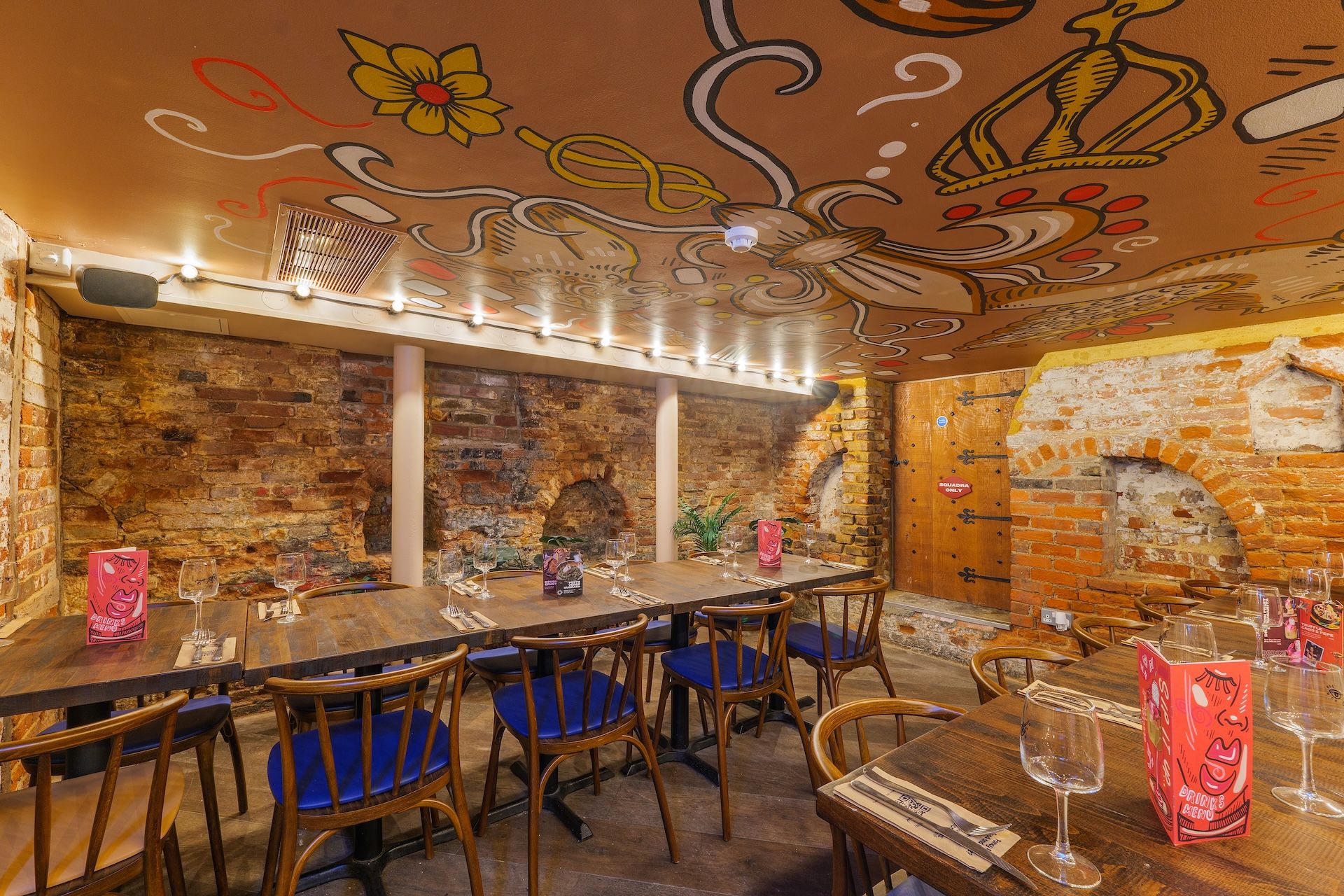 Zizzi Windsor cellar with ceiling murals and seating