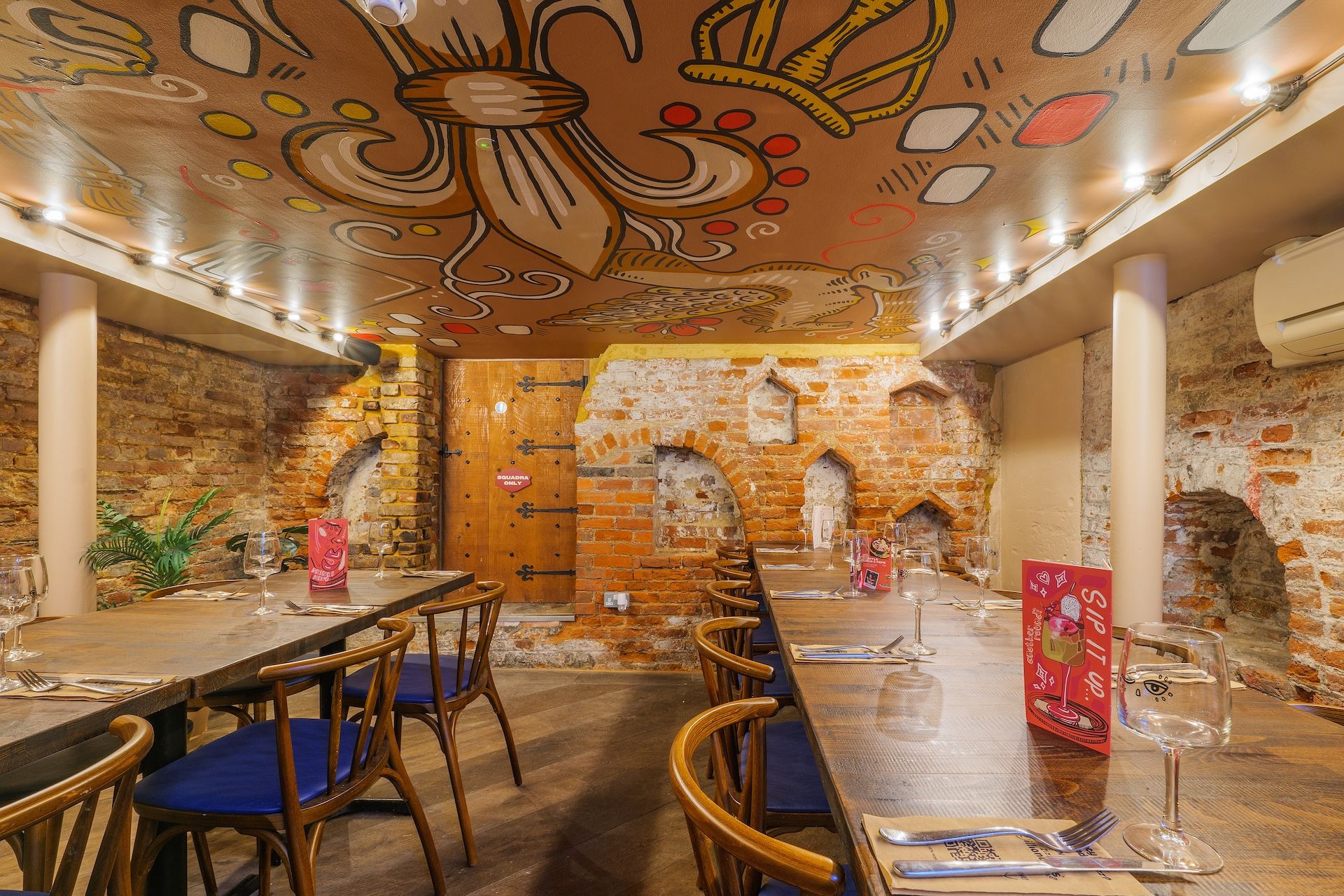 Zizzi Windsor cellar with ceiling murals and seating