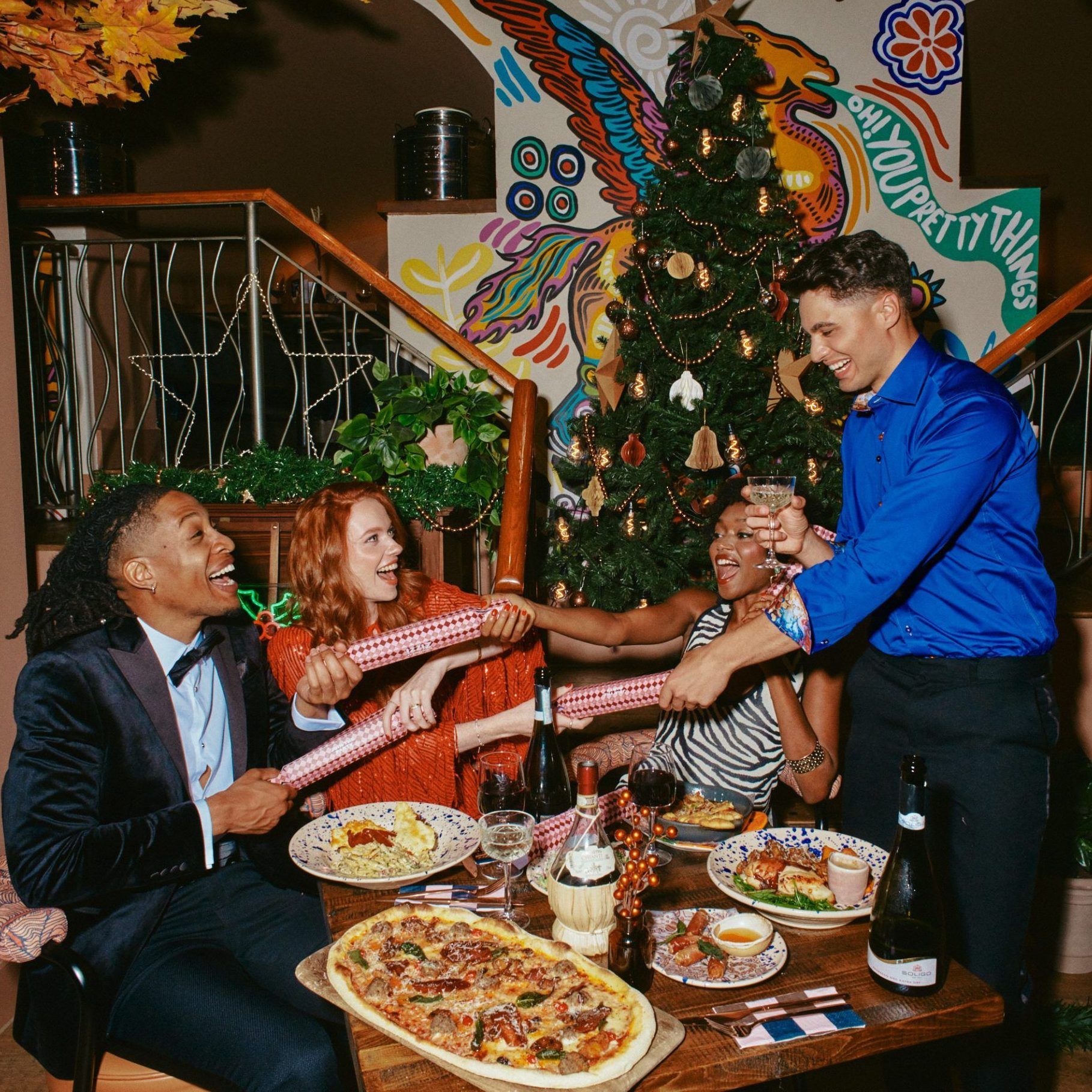 Group of people celebrating Christmas with crackers 
