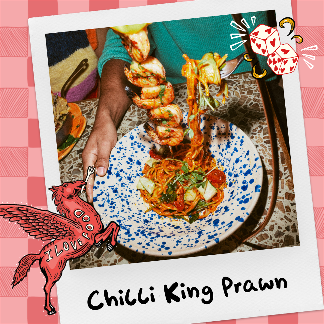 Chilli King Prawn pasta with hanging skewer of king prawns. 